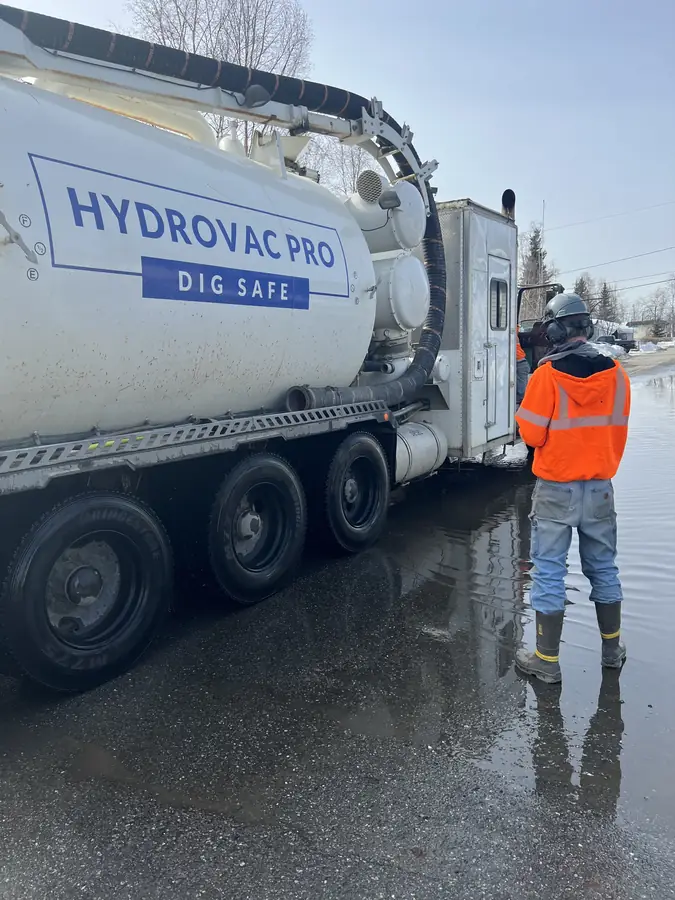 Hydrovac Pro technician beside the Dig Safe vacuum truck